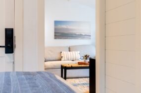Hotel bed with artwork and natural light