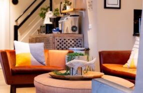 Bright lobby with orange chairs and white walls