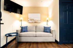 Room with couch, art, and TV