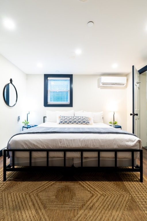Bright room with large bed and black frame