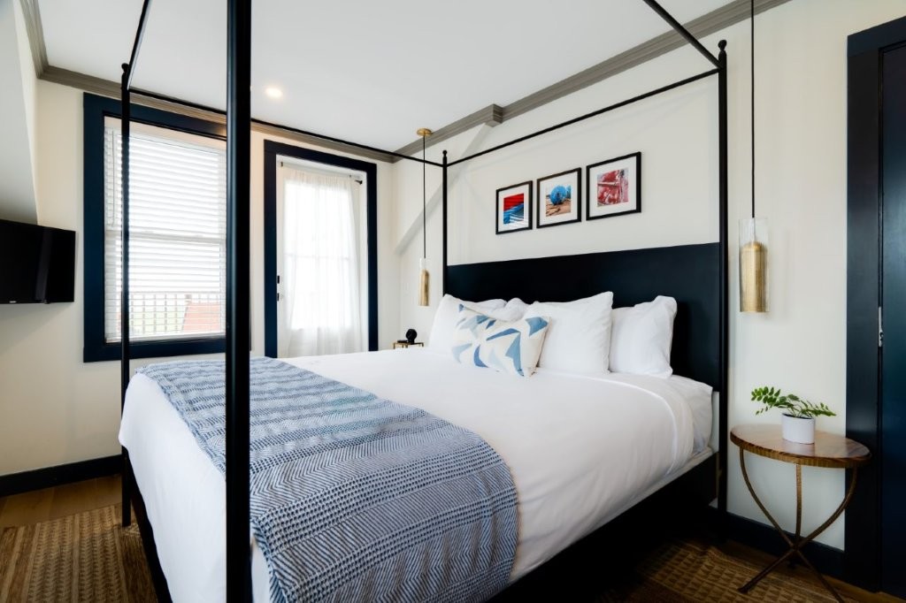 Guest room with art above bed