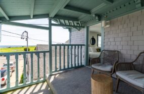Covered porch with chairs and soft lighting