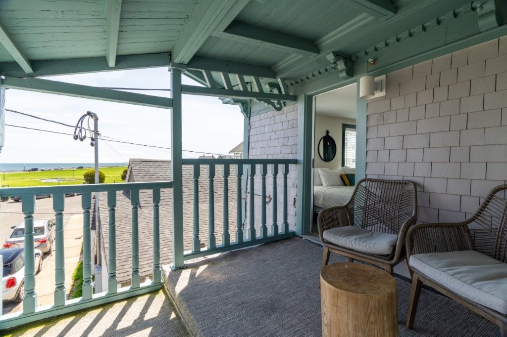 Covered porch with chairs and soft lighting
