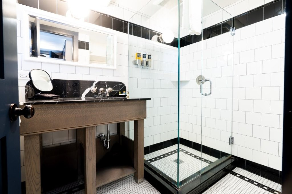 Bathroom with black vanity and glass shower