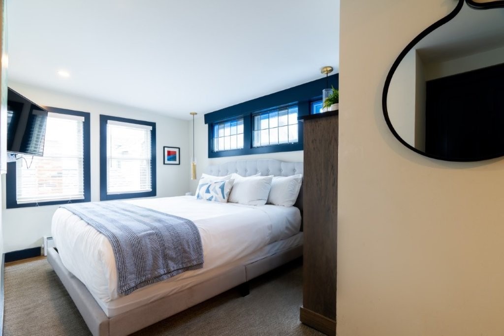 Room with plush bed and neutral tones