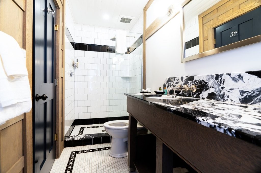 Bathroom with dark marble sink and shower