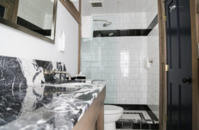 Bathroom with black marble sink and glass shower