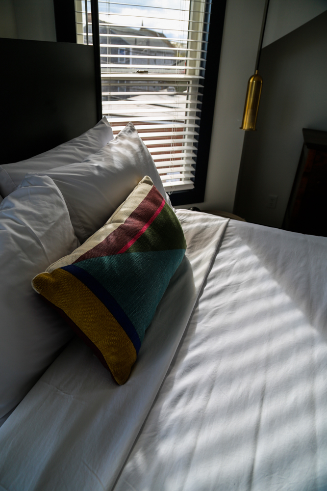 Close up of bed with colorful pillow