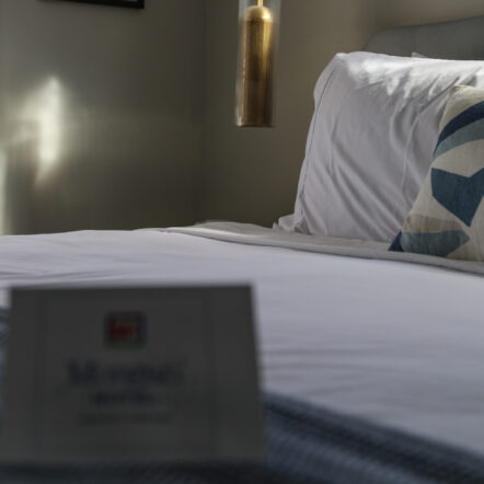 Close up of bed with soft pillows and wall art