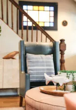Cozy reading chair next to staircase