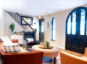Bright lobby with orange chairs and large windows