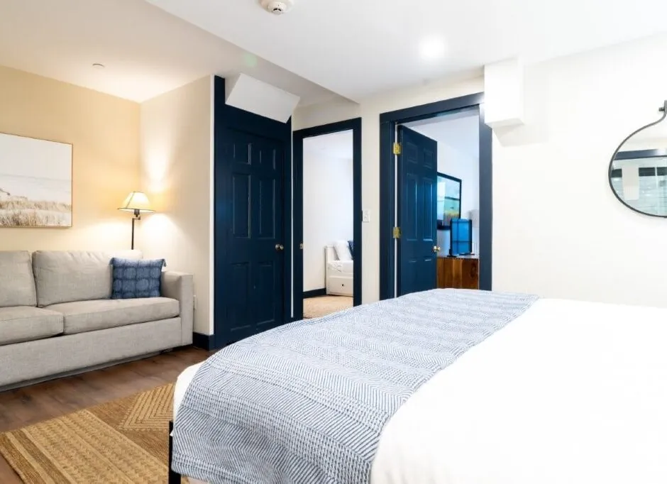 Angle view of guest bed with gray blanket