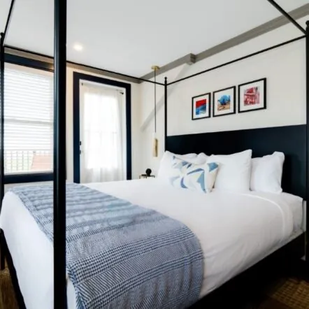 Guest room with art above bed