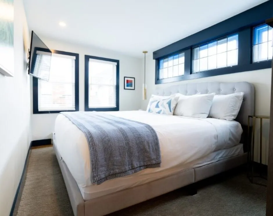 Soft gray and white bed in cozy room