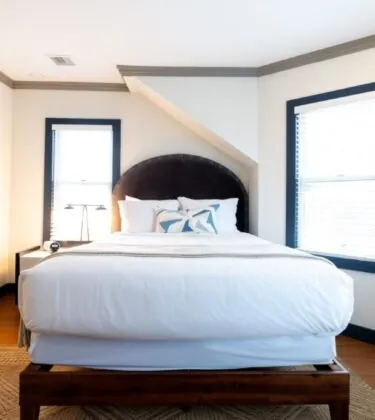 Room with arched headboard and soft lighting