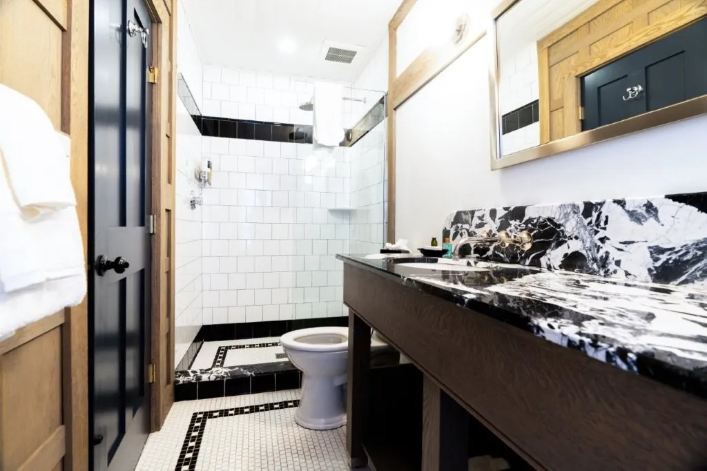 Bathroom with dark marble sink and shower
