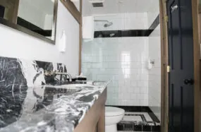Bathroom with black marble sink and glass shower