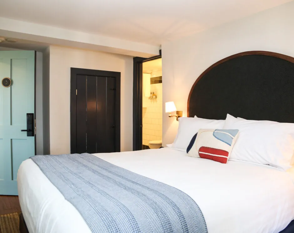 Bright room with bed and dark wood frame
